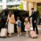 Family boarding a luxury Mercedes V-Class chauffeur vehicle outside a Sydney hotel with luggage for a private hotel transfer.