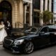 Couple arriving at a Sydney registry wedding ceremony with a luxury chauffeur-driven sedan near Pyrmont waterfront.